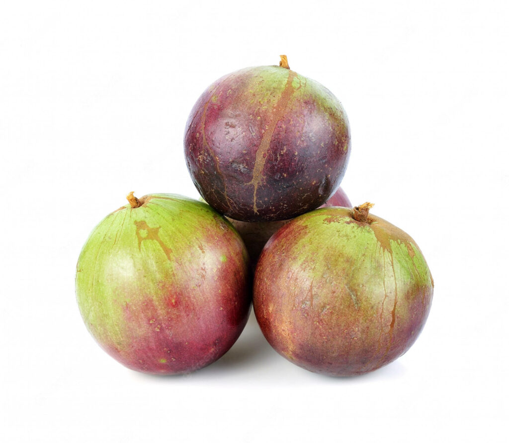 Three fresh purple star apples stacked triangularly on white background with smooth texture Wallpaper