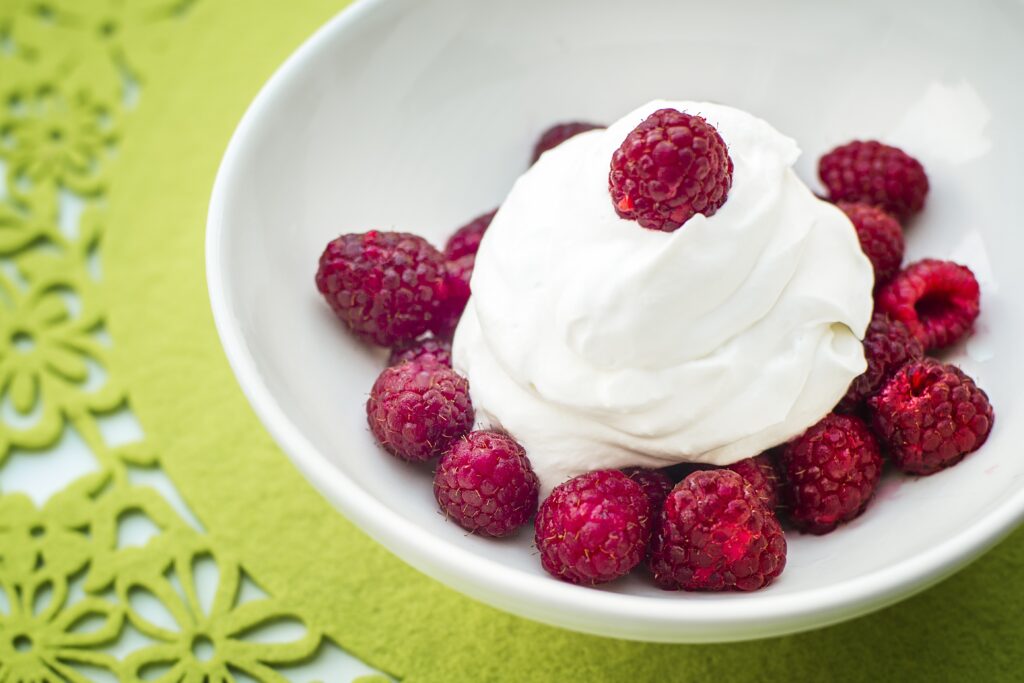 Fresh Raspberries in Cream: Vibrant Wallpaper Background Delight