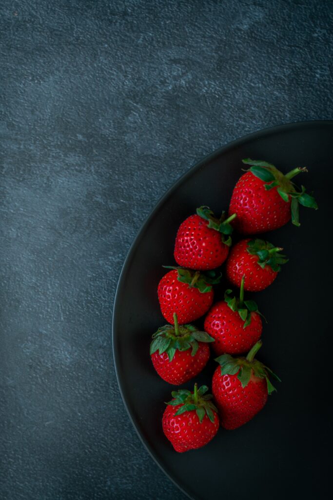 Fresh Red Strawberries on Dark Plate - Textured Gray Wallpaper