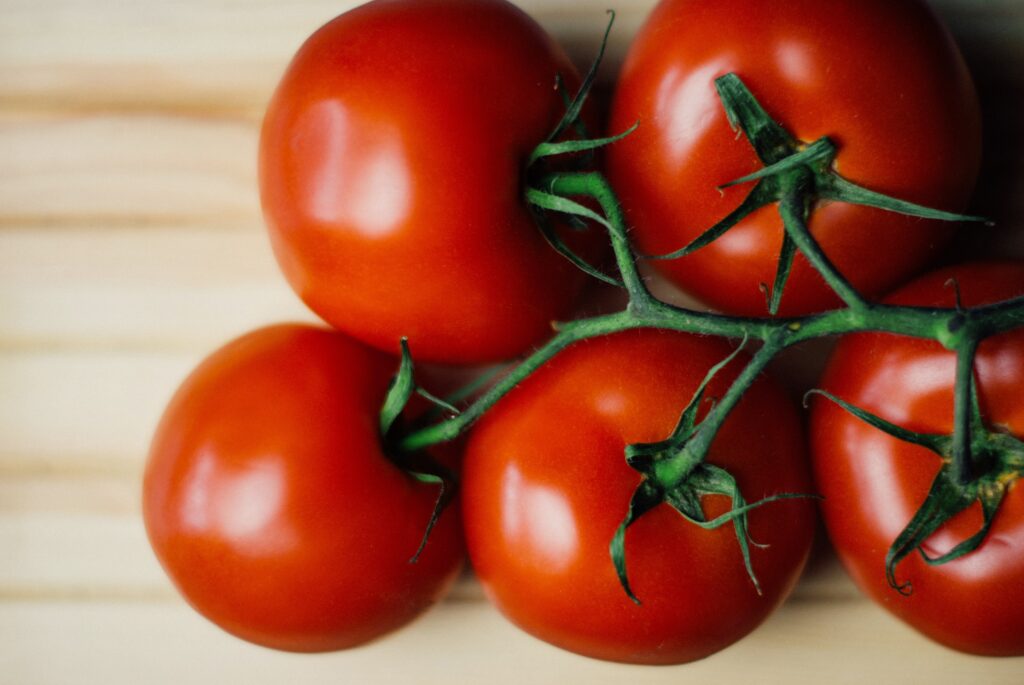 Fresh Red Tomatoes on Green Twig - Nutrient-Packed Wallpaper Background