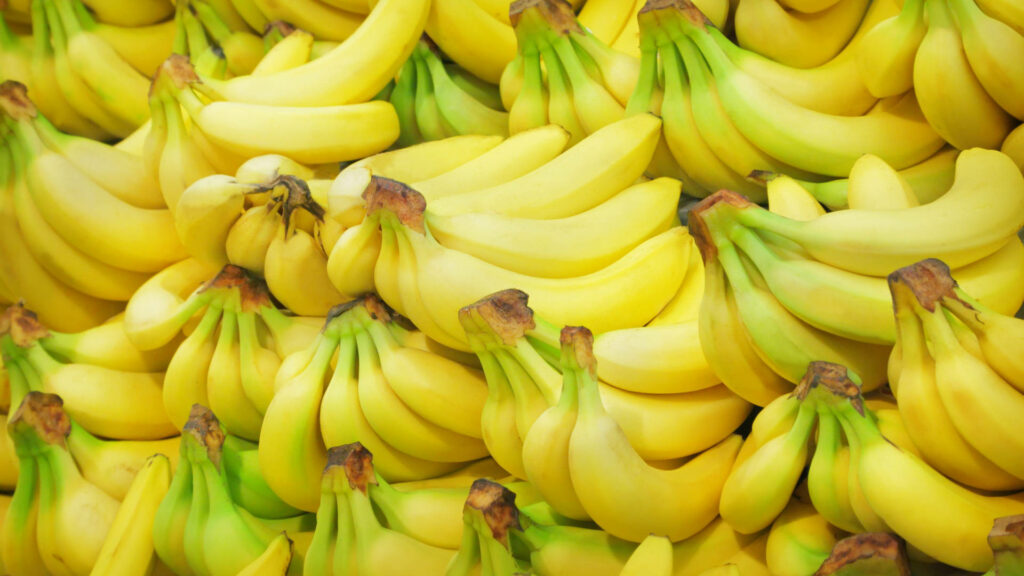 Vibrant wallpaper with a cluster of ripe yellow bananas showcasing fresh natural appeal