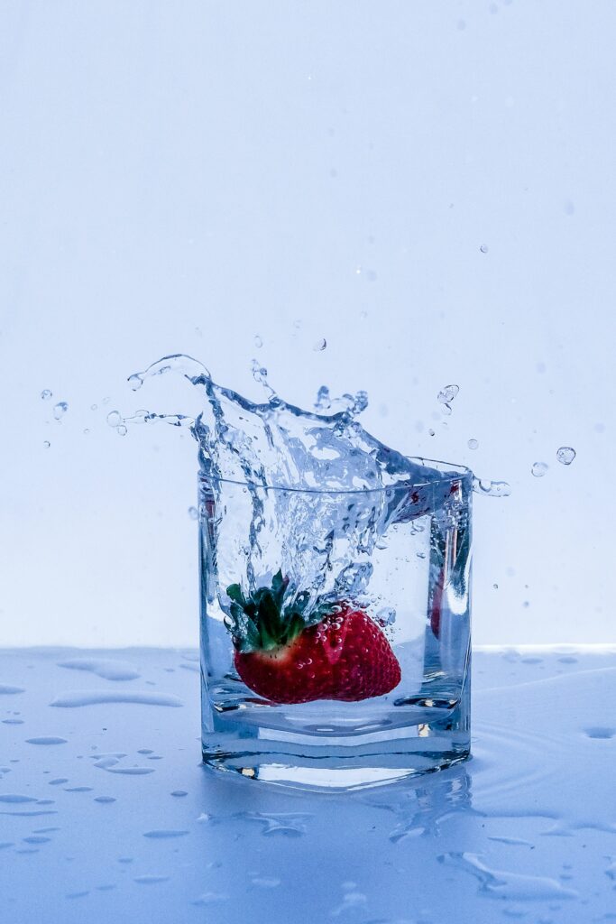 Fresh Strawberry Splash: Vibrant Water Wallpaper Background