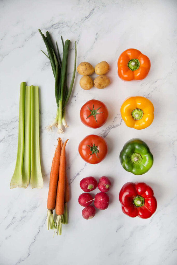 Vibrant Fresh Vegetables Wallpaper on White Marble Background