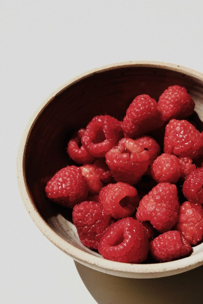 Vibrant Raspberries in Rustic Bowl - Close-Up Wallpaper Background