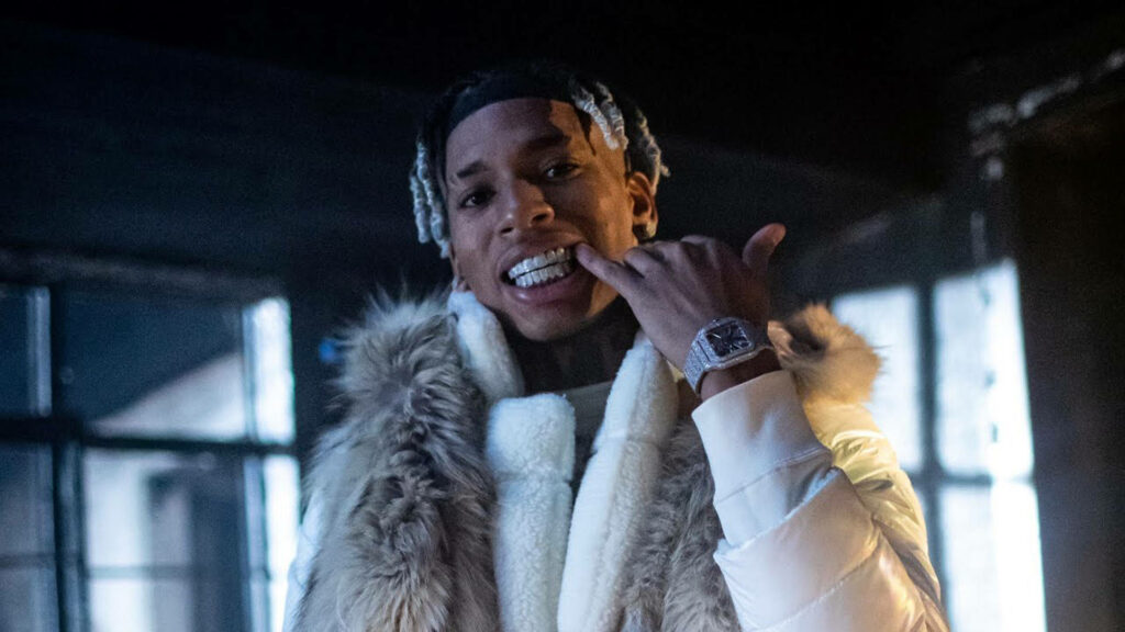 Fresh and Fly: NLE Choppa Rocks Stellar White Jacket in Wallpaper Shot