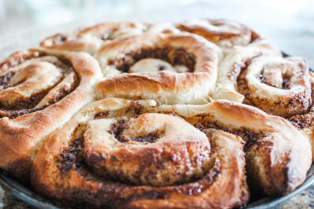 Close-Up of Golden-Brown Cinnamon Rolls Wallpaper Background