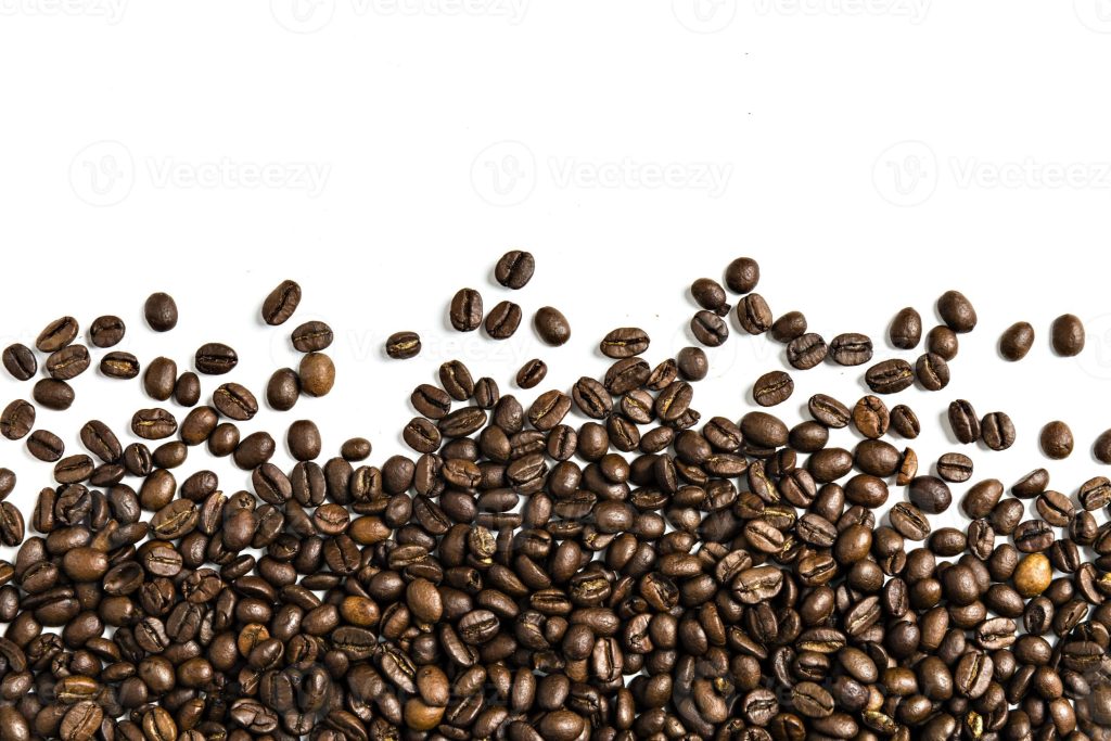 Freshly roasted coffee beans pile on white background rich brown tones aromatic wallpaper