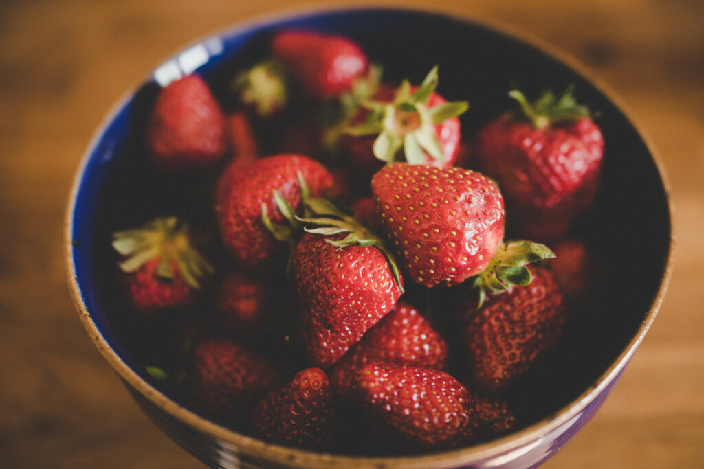 Fresh Red Strawberries in Ceramic Bowl - Vibrant Wallpaper Background