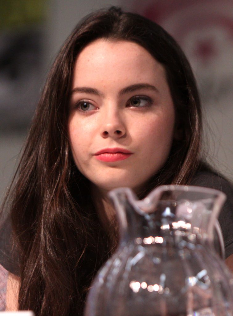 Candid close-up of actress Freya Tingley with soft lighting and blurred glass carafe foreground Wallpaper