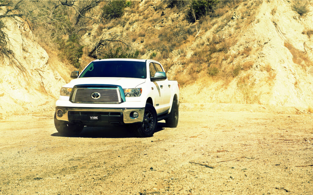White Toyota Tundra Front View in Rugged Rocky Hills - Adventure Awaits Wallpaper