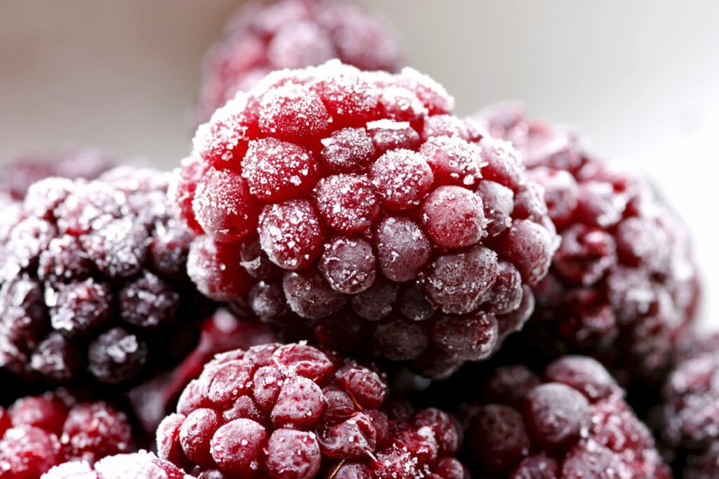 Frosty Red Raspberries: Close-Up Wallpaper Background Image