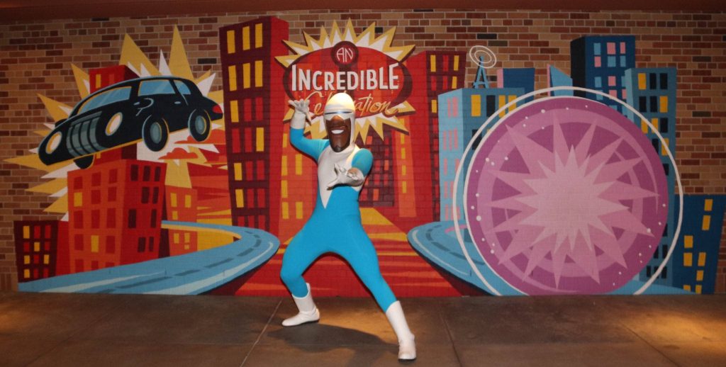 Frozone superhero pose with vibrant An Incredible Celebration mural at Disney Hollywood Studios Wallpaper
