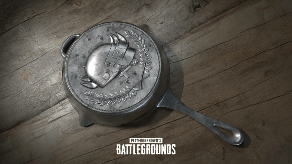 PUBG frying pan with embossed helmet on rustic wooden table CGI wallpaper background