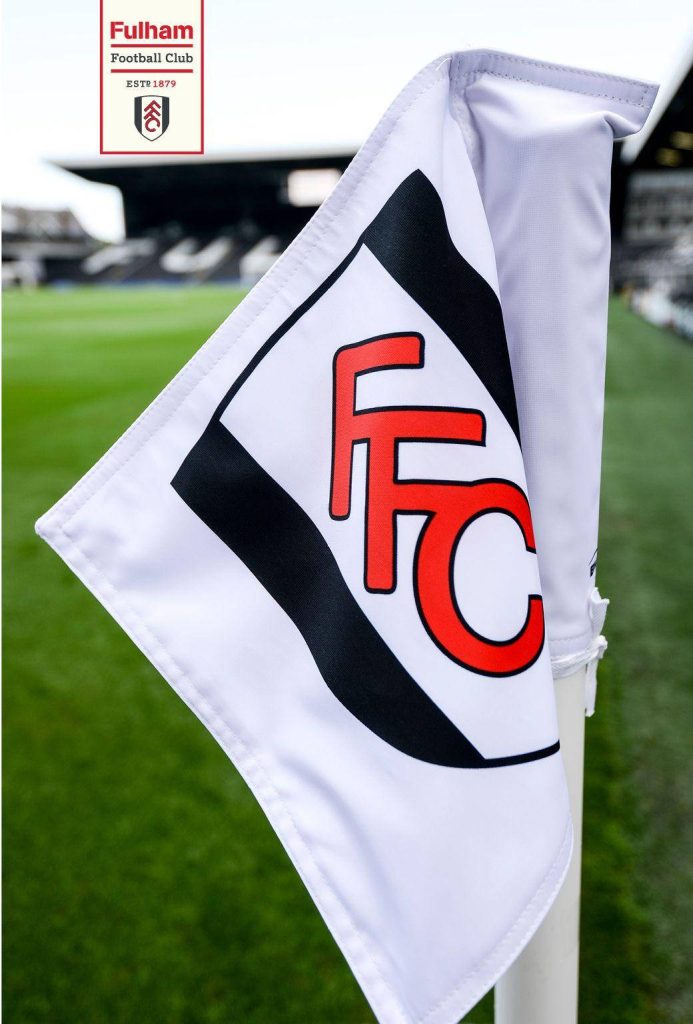 Fulham FC corner flag with red black crest on white waving at stadium pitch background wallpaper