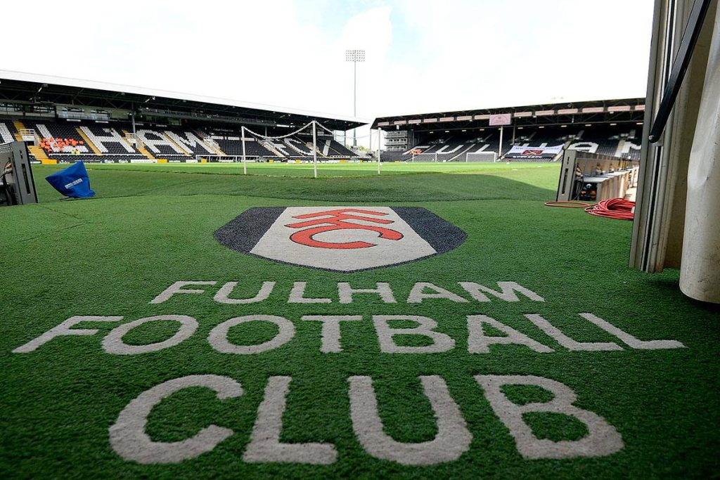 Fulham FC crest and name on Craven Cottage turf from tunnel view daylight stadium wallpaper