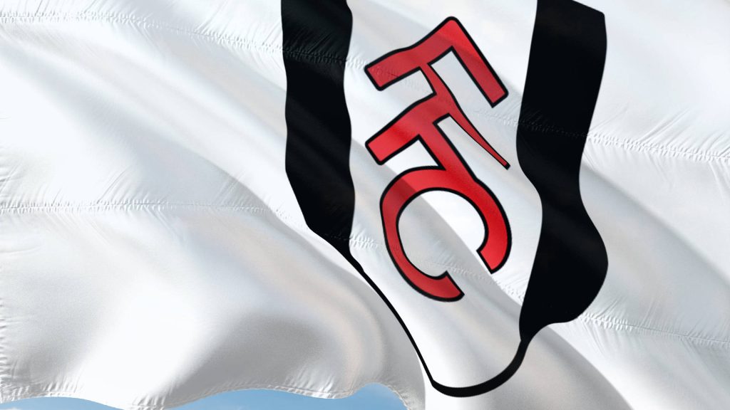 White Fulham FC flag with bold red FFC monogram waving on sleek black CGI wallpaper background