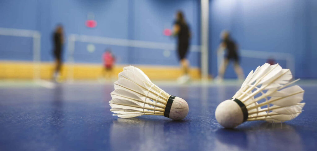 Dynamic Duel: Capturing the Intensity of Professional Badminton Players in Action Wallpaper