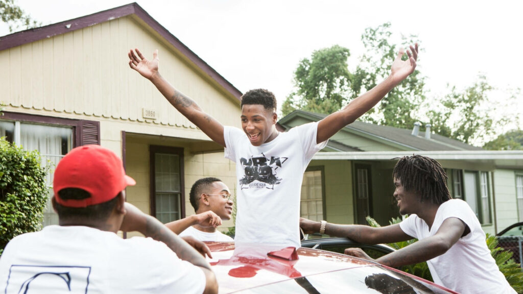 Friendship in Motion: NBA Youngboy's Joyful Moments with His Crew - Wallpaper featuring NBA Youngboy embraced by the love and laughter of his closest friends in a beautiful background