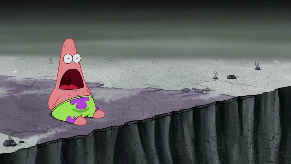 Funny shocked Patrick Star wallpaper on grey cliffside SpongeBob SquarePants meme background