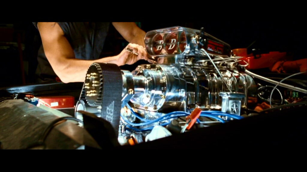 Revved Up: A High-Definition Wallpaper of a Speedy Car Engine in the Fast and Furious Zone