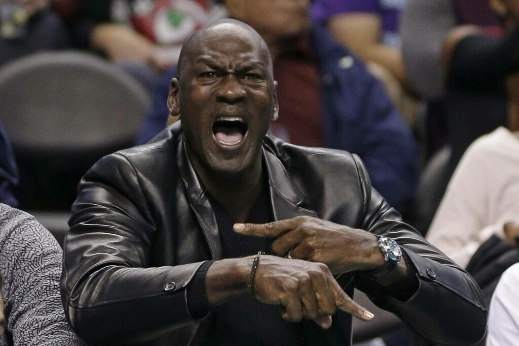 Michael Jordan's Intense Reaction to a Game, Captured in a Stylish Black Leather Jacket Wallpaper
