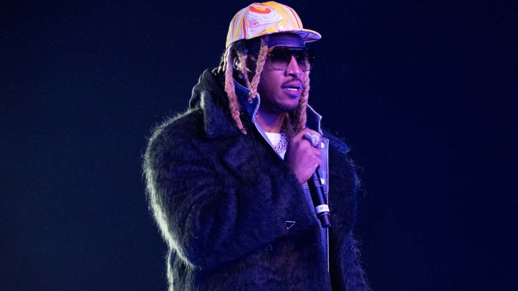 Rapper Future performing live in dark coat colorful cap purple stage lights concert wallpaper