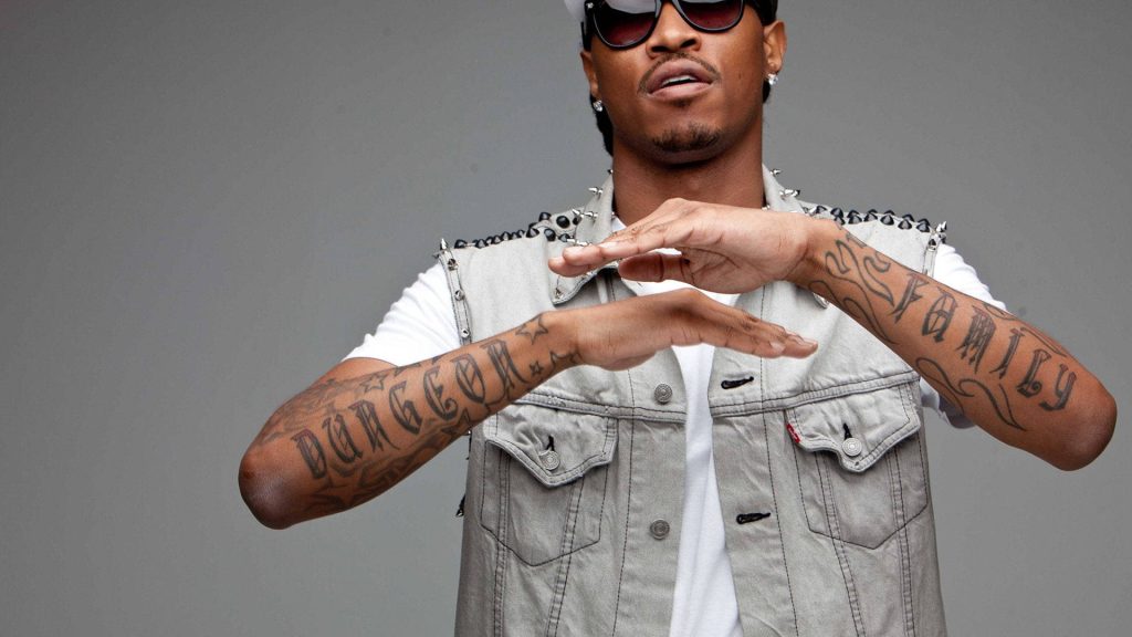 Portrait of rapper Future with spiked denim vest dark sunglasses and Dungeon Family tattoos Wallpaper