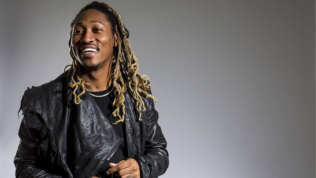 Rapper Future portrait with dreadlocks black leather jacket silver chain grey studio background Wallpaper