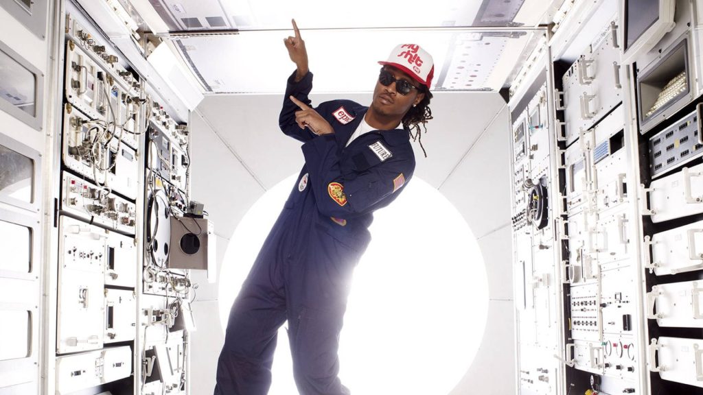 Future rapper in navy jumpsuit inside futuristic spacecraft module hip-hop wallpaper background