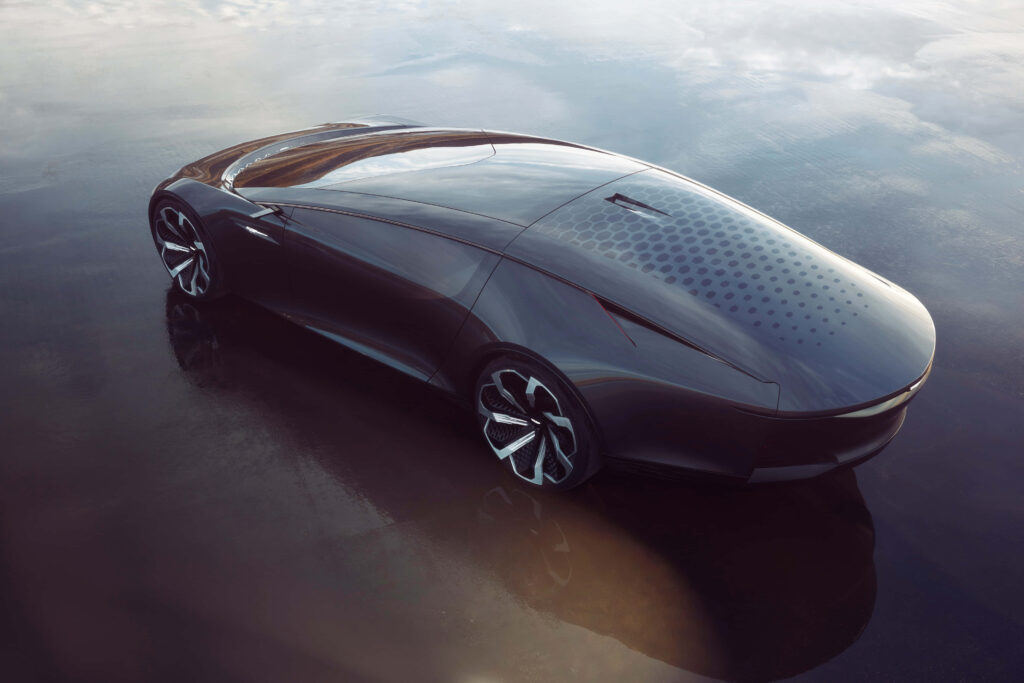Futuristic autonomous vehicle with sleek aerodynamic design gliding on reflective surface wallpaper