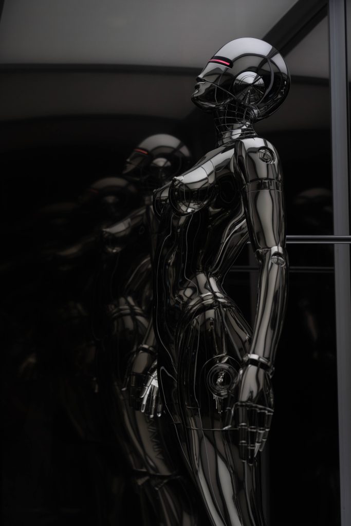 Futuristic CGI wallpaper of black chrome female androids with glowing red visors in dark lighting