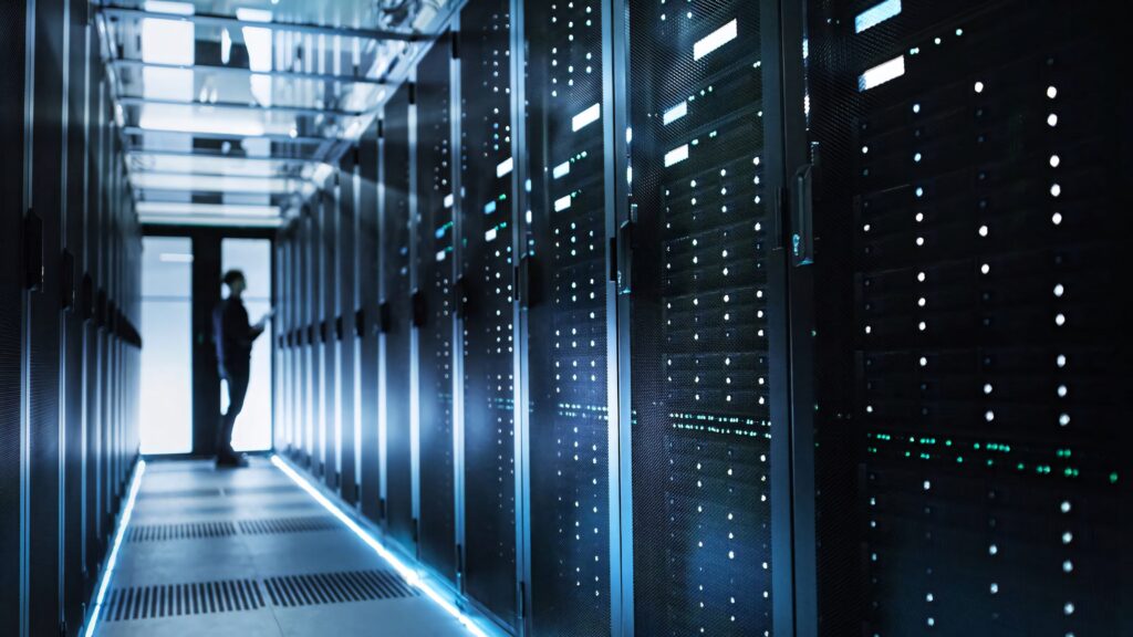 High-tech data center with illuminated server racks in blue tones showcasing advanced technology Wallpaper