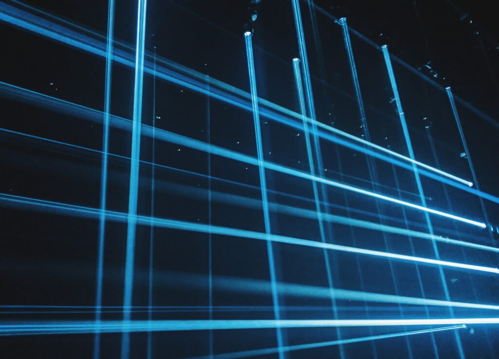 Futuristic Blue Light Rays Wallpaper - Dynamic Grid Pattern Background