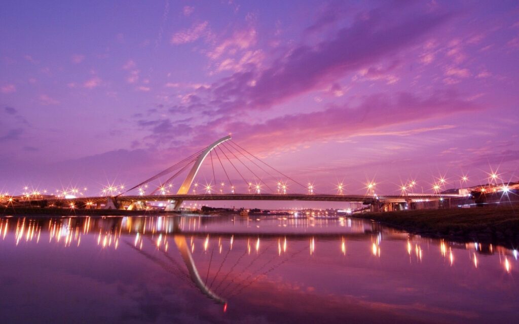 Futuristic City Bridge: Neon Lights & Serene Dusky Water Wallpaper