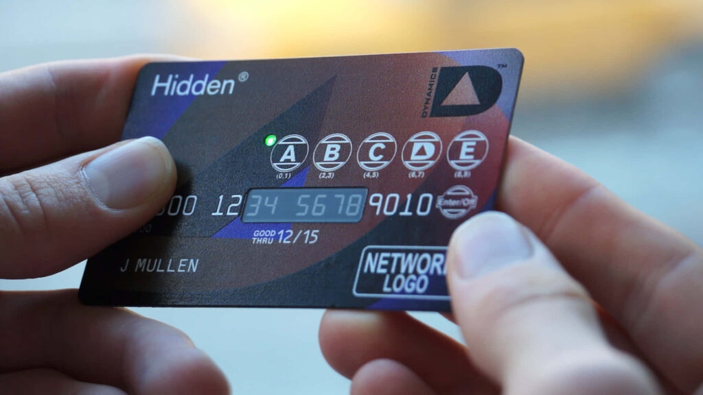 Person holding futuristic credit card with illuminated numbers and advanced security features Wallpaper