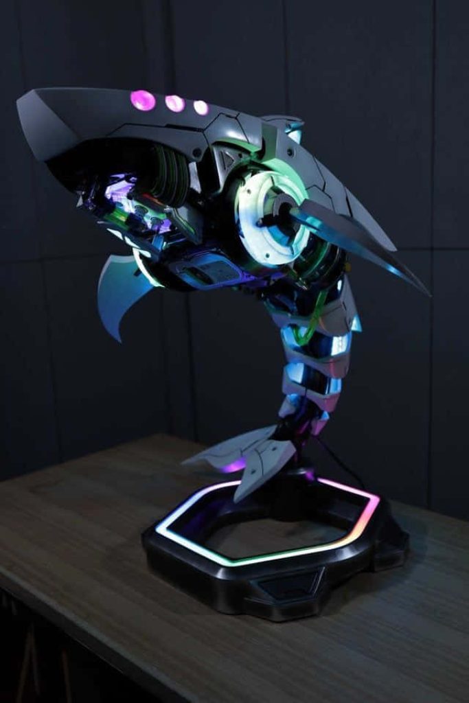 Custom Shark PC mod with RGB lighting futuristic cybernetic design on hexagonal base gaming setup Wallpaper