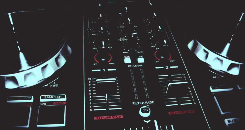 Close-up of modern DJ controller with glowing red and white knobs and faders on dark background Wallpaper