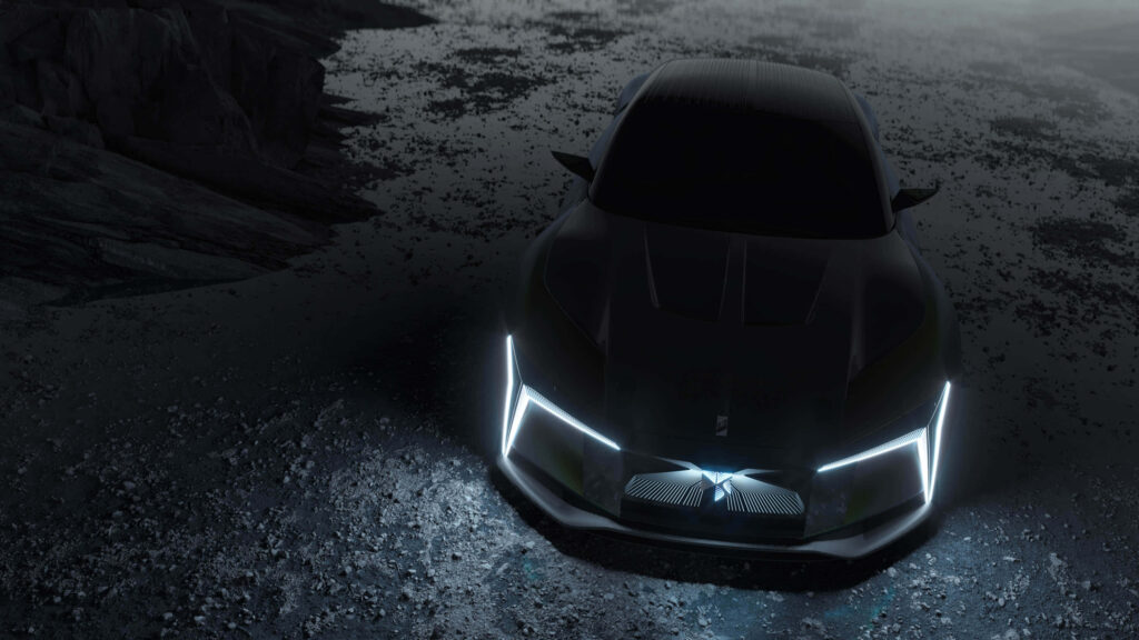 Futuristic DS Automobiles car with sharp LED headlights and sleek lines in misty landscape background Wallpaper