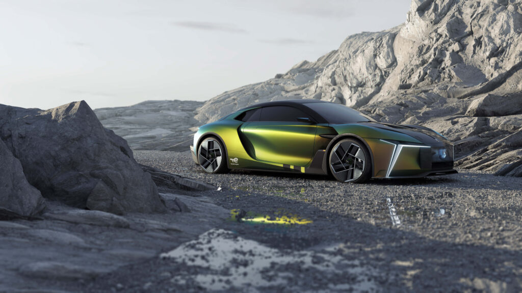 Sleek DS Automobiles concept car with iridescent finish on rocky landscape under muted sky wallpaper