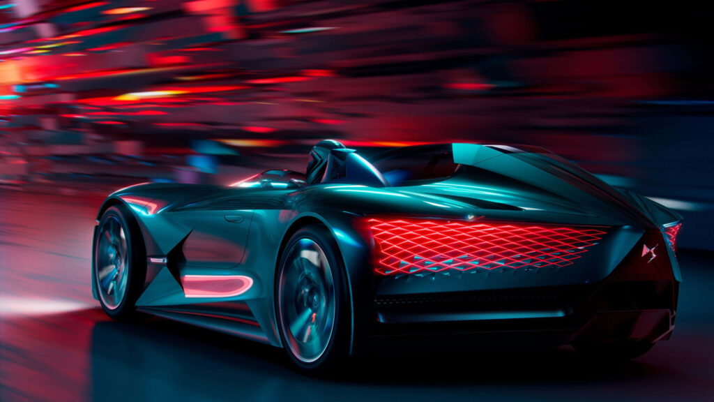 Futuristic DS Automobiles concept car with neon lights speeding through vibrant cityscape background Wallpaper