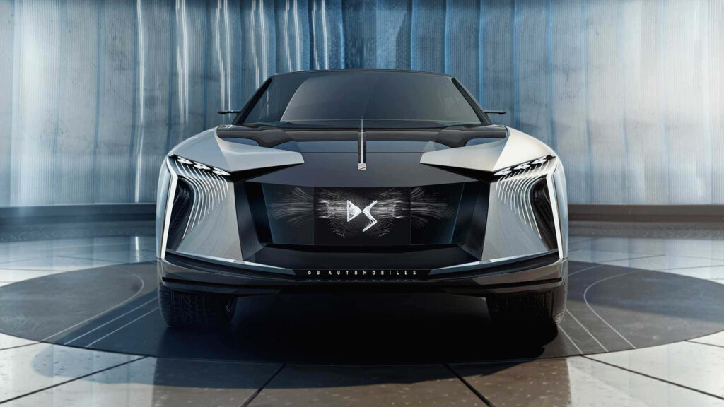 Futuristic DS Automobiles concept car with sharp lines and illuminated DS logo on grille background Wallpaper