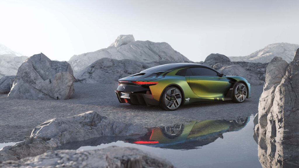 DS Automobiles concept car in rocky landscape with green gold gradient reflected in still pool Wallpaper