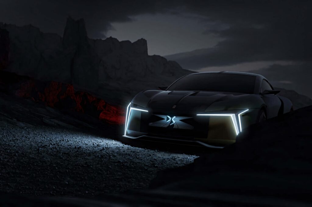 Futuristic DS Automobiles car with LED lights on rugged dark landscape red and blue tones wallpaper
