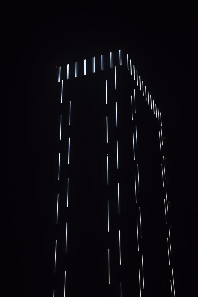 Futuristic Dark Building Wallpaper with Vertical White Light Strips