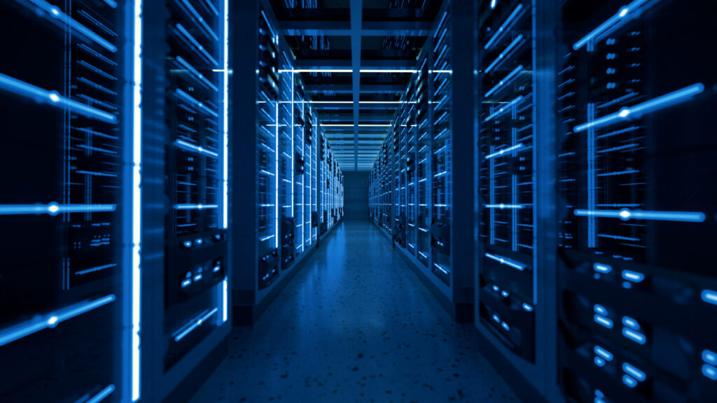 Futuristic data center with glowing blue server racks and sleek metal surfaces in dark tones Wallpaper