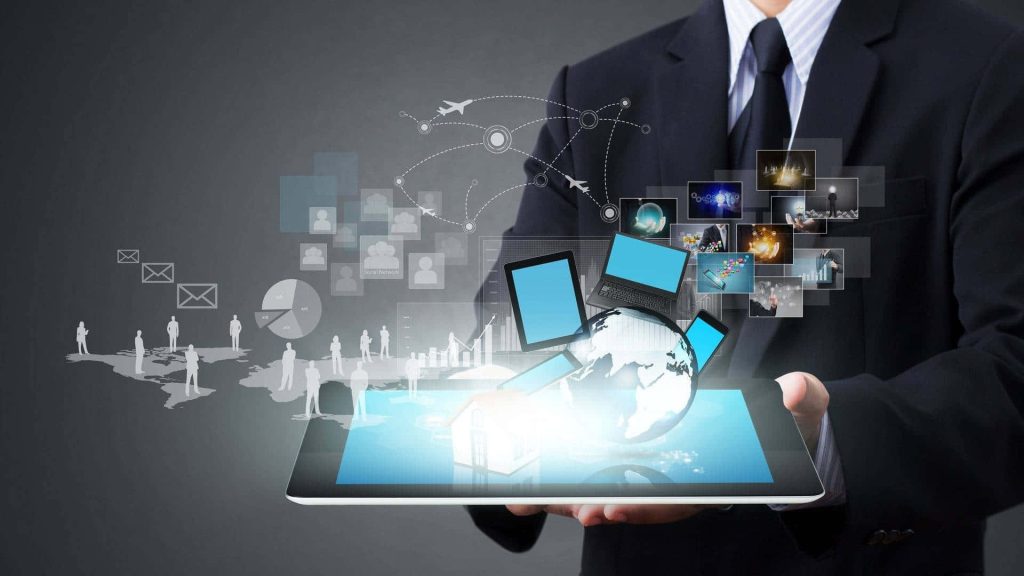 Businessman holding glowing tablet with holographic globe and digital network in blue light Wallpaper