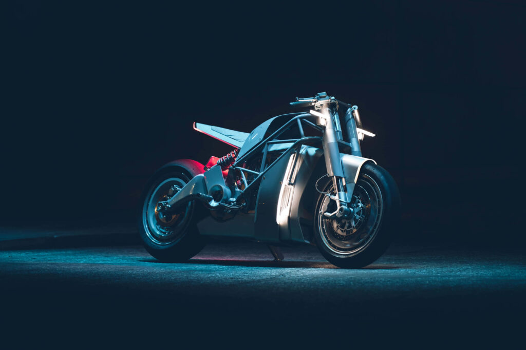 Futuristic electric bike with sleek metallic design in blue and red lighting on minimal background Wallpaper