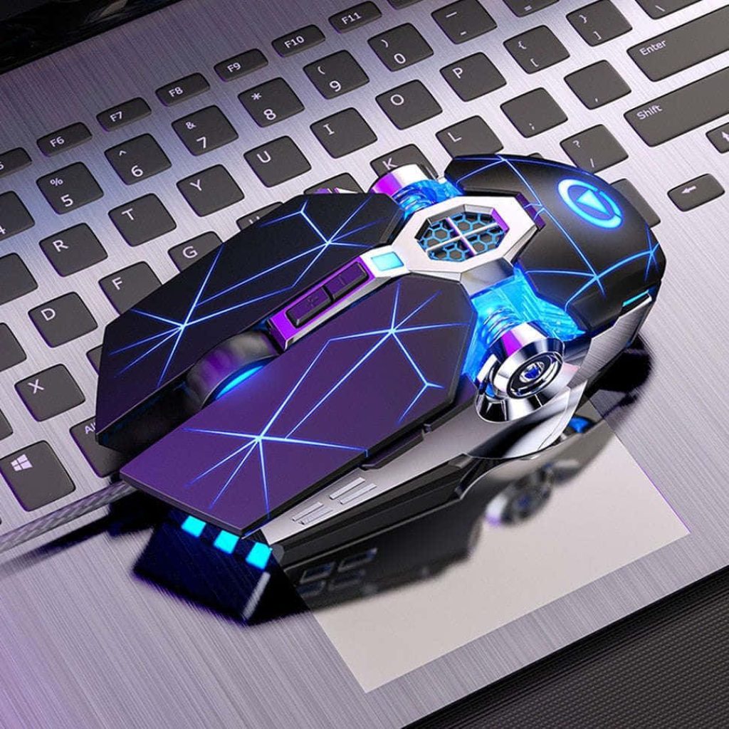 Futuristic gaming mouse with blue LED geometric design on laptop keyboard wallpaper background
