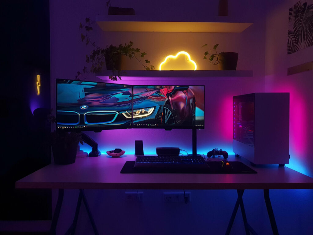 Sleek Minimalist Gaming Room with LED Lights and Dual Monitors Wallpaper