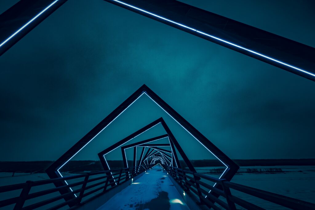 Geometric bridge with blue backlighting at night modern architectural design wallpaper background